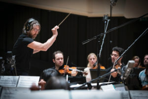 Peter Nordahl conducting the recording of the soundtrack for the film "Sara med allt sitt väsen."